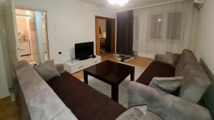 a living room with a couch and a table at Apartment for Rent in Gjilan
