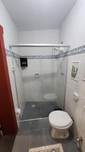 a small bathroom with a toilet and a shower at CASA DOS SINOS in São João del Rei