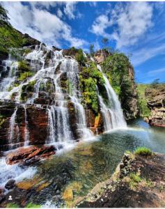 a waterfall on the side of a mountain at Pousada Fazenda São Bento in Alto Paraíso de Goiás