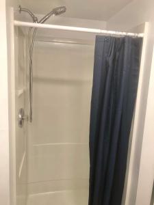 a shower with a blue shower curtain in a bathroom at Cute one bedroom by Airport in Minneapolis