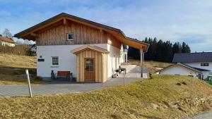 una piccola casa con tetto in legno su una collina di Ferienhaus Herbstzauber a Haidmühle