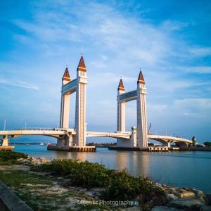 a large bridge over the water with a blue sky at Rayyaz Inn in Kuala Terengganu +28 photos