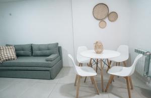 a living room with a couch and a table and chairs at MI LUGAR * CHIVILCOY in Chivilcoy