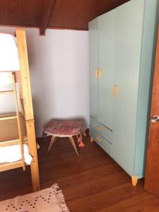 een slaapkamer met een stapelbed, een ladder en een kruk bij Departamento cerro de la cruz in Punta Arenas