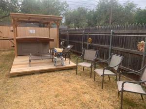 a wooden deck with chairs and a gazebo at Luxury Oasis- 1 bedroom romantic getaways in Lubbock