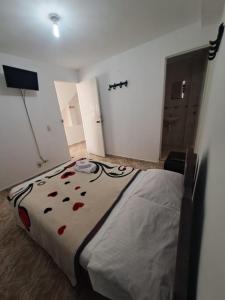 a bedroom with a large bed in a room at Hotel Las Dalias in Guatapé