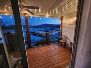 a screened in porch with a view of a lake at Peaceful 1st floor lakeside condo minutes from Osage Beach and Ozark State Park in Kaiser