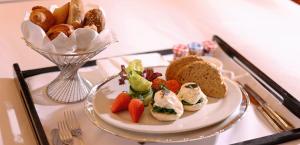 a plate of food on a table with bread and fruit at Radisson Collection Hyland Shanghai in Shanghai