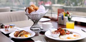 a table with two plates of food and a basket of bread at Radisson Collection Hyland Shanghai in Shanghai