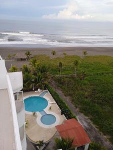 a view of the beach from the balcony of a building at PH OLAS TOWERS FRONT. PLAYA LA BARQUETA in Chiriquí