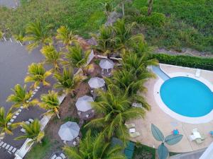 an aerial view of a resort with a pool and palm trees at PH OLAS TOWERS FRONT. PLAYA LA BARQUETA in Chiriquí