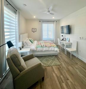 a bedroom with a bed and a chair and a desk at The View suites and breakfast in Triton, Newfoundland in Pilleyʼs Island