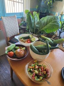 a wooden table with plates of vegetables on it at Urban Farm House +Hot Tub+Pool in Long Beach