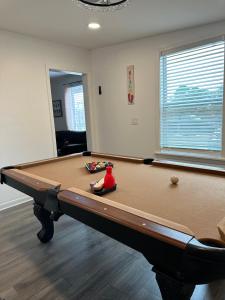 a billiard table in a living room with afits at Fenced House Beach Walk Sleeps 16 near St Andrew Park - Schooners in Panama City Beach