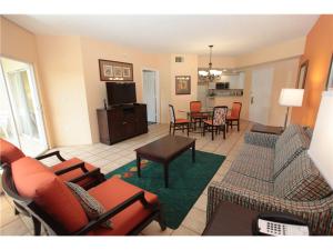 a living room with couches and a dining room at Be Our Guest in Orlando