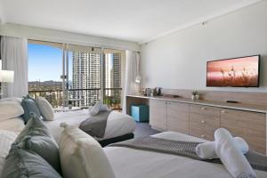 a bedroom with two beds and a large window at Cosy 2-Bed Central Studio Apartment With Views in Gold Coast