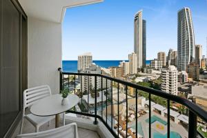 a balcony with a table and chairs and a view of the ocean at Cosy 2-Bed Central Studio Apartment With Views in Gold Coast