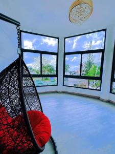a room with a hammock in a room with windows at Sai Gon Ha Tien Hotel in Hà Tiên