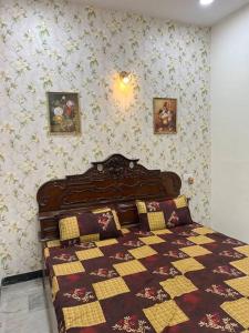 a bedroom with a bed with a quilt on it at Authentic Indian Culture in Panchkula