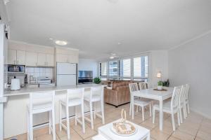 a kitchen and living room with a table and chairs at Oceanview Delight in Gold Coast
