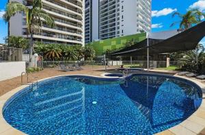 a large pool with blue water in front of a building at Oceanview Delight in Gold Coast