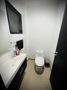 Habitación en Querétaro Capital في Tlacote el Bajo: حمام ابيض مع مرحاض ومغسلة