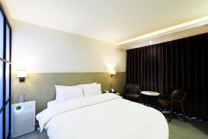 Postelja oz. postelje v sobi nastanitve CS Avenue Tourist Hotel