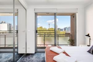 a bedroom with a bed and a large window at The Earl - Potts Point Paradise with Sydney Views in Sydney