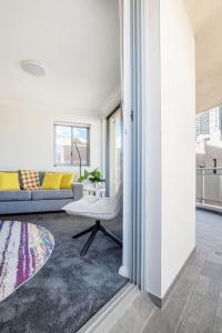 a living room with a couch and a table at The Earl - Potts Point Paradise with Sydney Views in Sydney