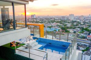 a view of the city from the balcony of a building at Comfty, Chic & Spacious Room with Parking & WiFi in Manila
