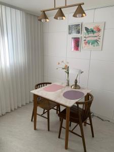 a dining room table with two chairs and a lamp at Comma 2, Cozy Semi-basement in Seoul