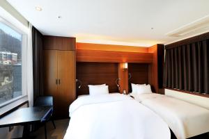 Postelja oz. postelje v sobi nastanitve CS Avenue Tourist Hotel