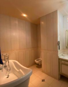 a bathroom with a tub and a toilet and a sink at Apartment Tbilisi View in Tbilisi City