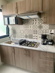 a kitchen with a sink and a counter top at Cómodo Loft Tequis. Facturamos in San Luis Potosí