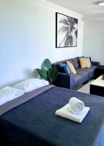 a hotel room with a bed and a couch at Aqualine Apartments On The Broadwater in Gold Coast