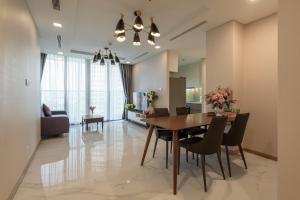 a dining room and living room with a table and chairs at Vinhomes Central Park Apartment- Landmark Luxury in Ho Chi Minh City