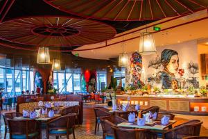 a restaurant with tables and chairs and a bar at Panorama Luxury Beach Front Residences in Nha Trang
