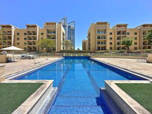 a large swimming pool in front of a building at Silkhaus The Greens neighborhood newly furnished 1BDR in Dubai