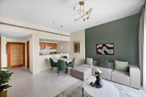a living room with a couch and a table at Silkhaus The Greens neighborhood newly furnished 1BDR in Dubai