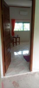 an open door to a living room with a table at pulau weh sabang marifi in Paya