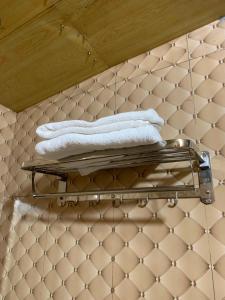 two towels on a towel rack on a tiled floor at Mao Sapa trekking and homestay in Sa Pa