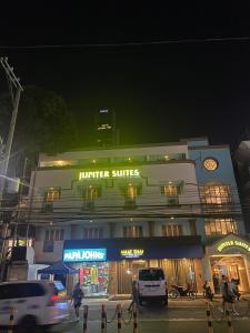 a building with a store with aiger strings sign on it at Jupiter Suites in Manila
