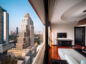 a room with a view of a tall building at Bandara Suites Silom, Bangkok in Bangkok