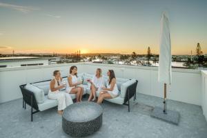 a group of women sitting on a roof at Villa Parkana - Beachside Buddina in Buddina