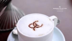 a cup of coffee with a heart drawn in it at Radisson Collection Hyland Shanghai in Shanghai