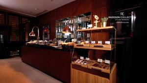 a restaurant with a counter with food on display at Radisson Collection Hyland Shanghai in Shanghai