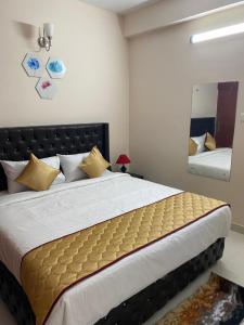 a bedroom with a large bed and a mirror at OM SRINIVASA - TRULY HOMESTAY in Tirupati