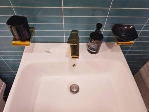 a white bathroom sink with two bottles of soap at Terrace House Hwagok station in Seoul