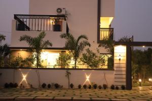 a house with lights on the side of it at Hidden beach stay in Chennai