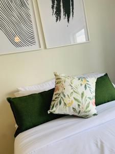a white bed with a pillow on top of it at Nelly`s Green Creek Luxury Apartment in Pretoria